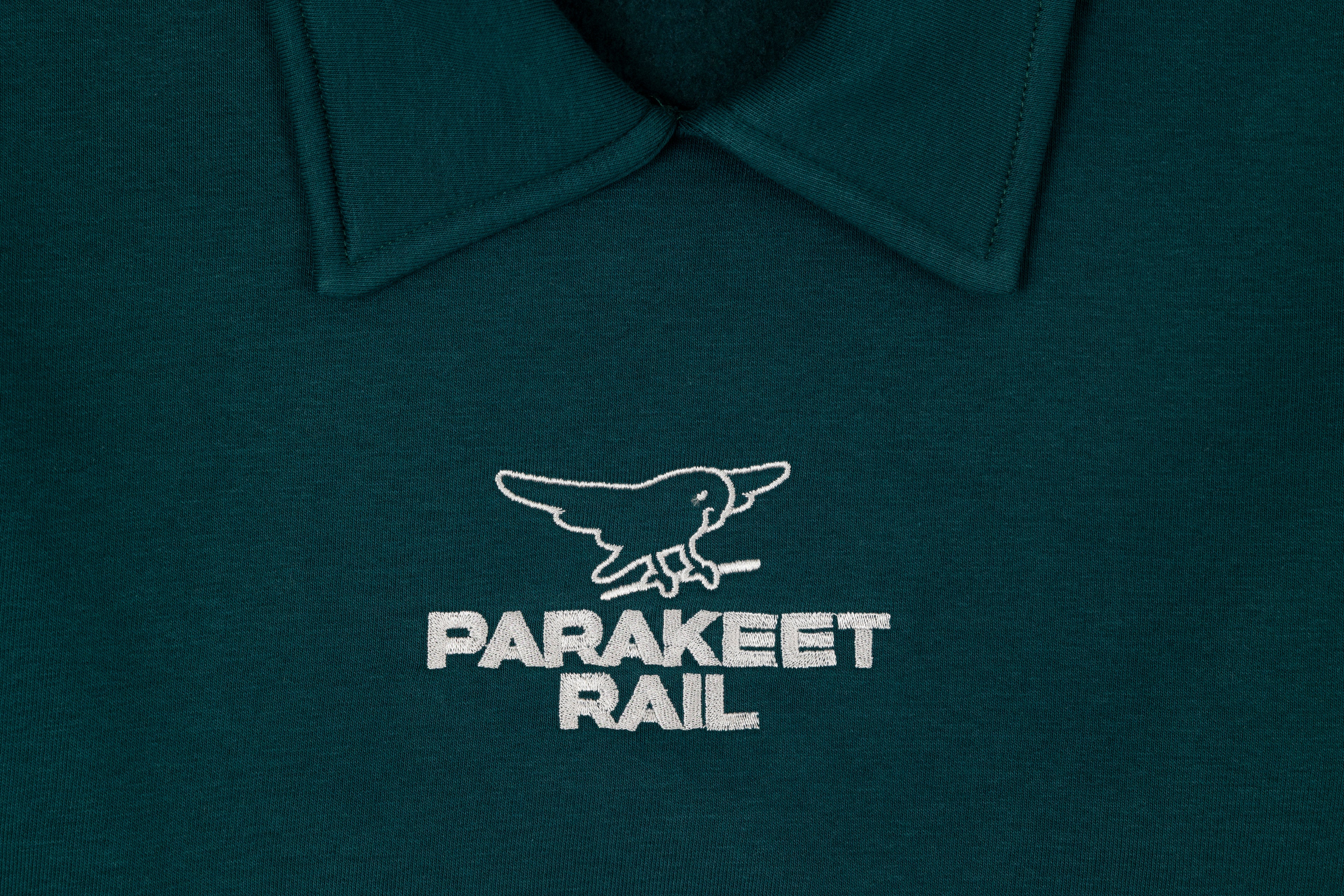 Parakeet Rail's petrol crop top shown from the front.