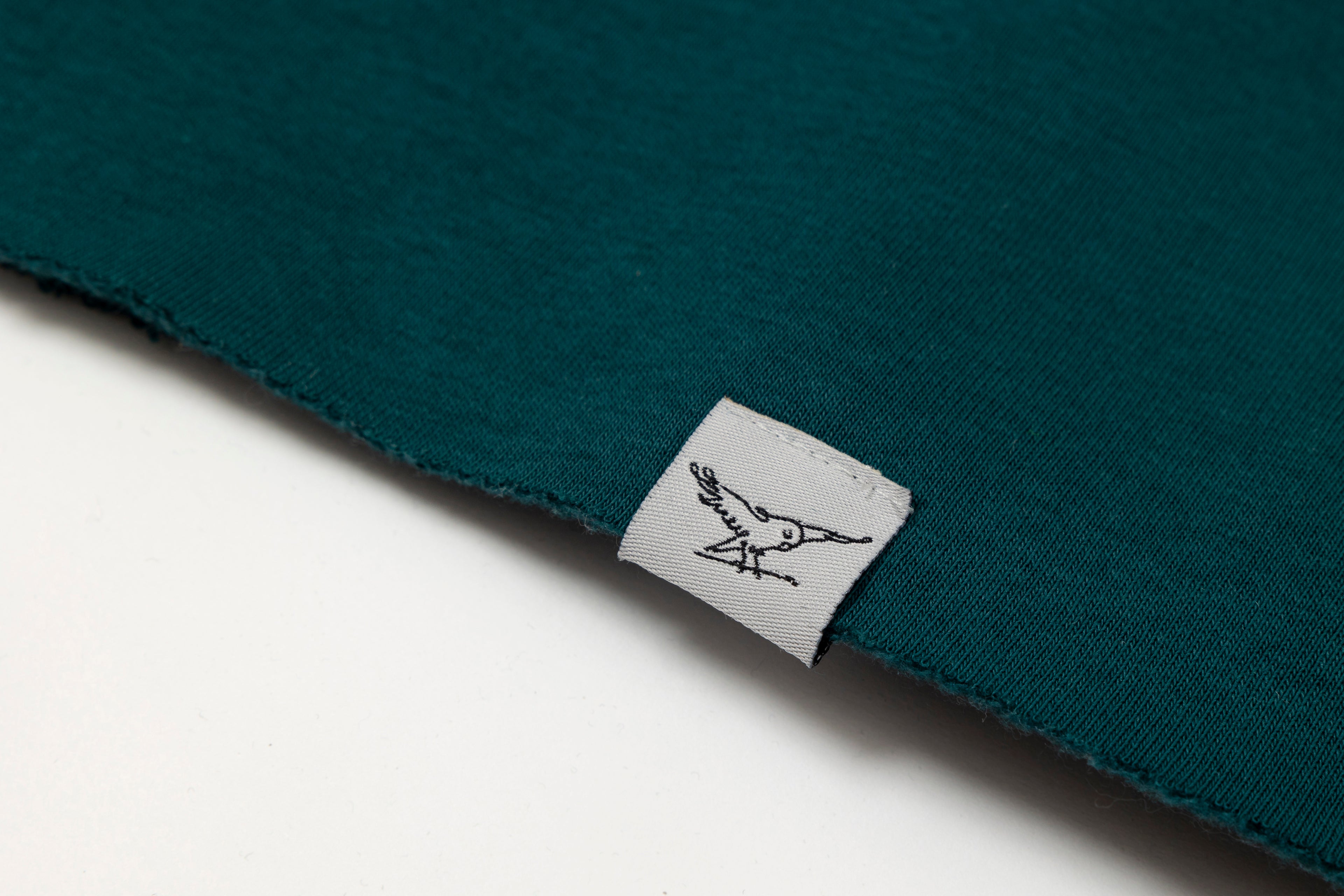 Parakeet Rail's petrol crop top shown from the front.